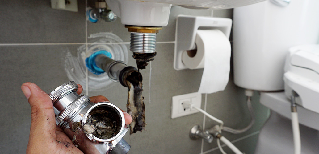 clearing gunk in blocked toilet sink