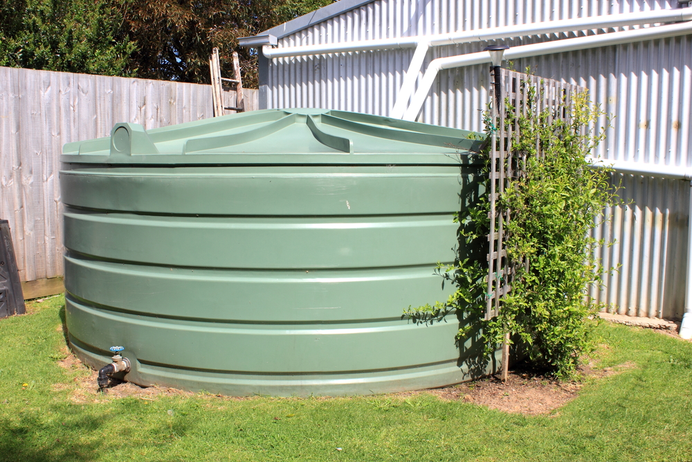 Large eco-friendly water storage tank in suburban backyard