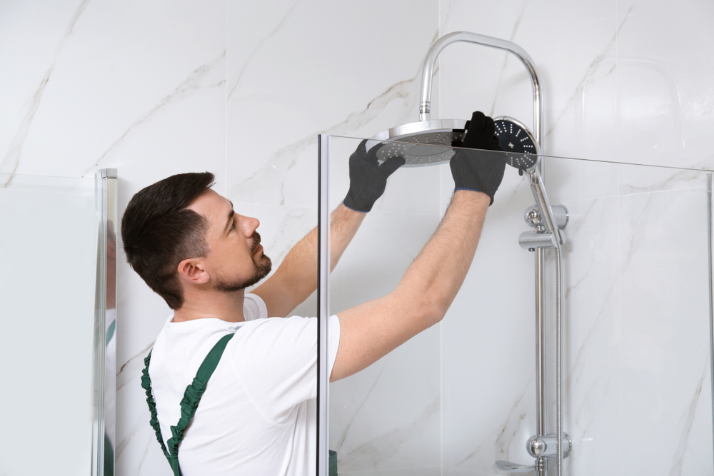 Plumber installing shower in bathroom