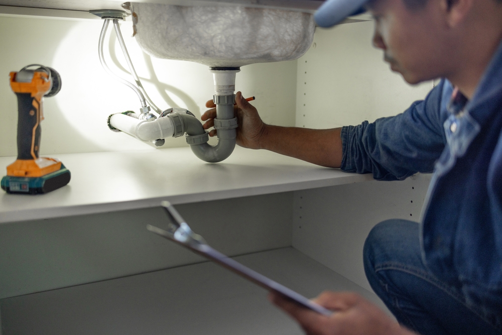 Plumber Inspecting Pipes